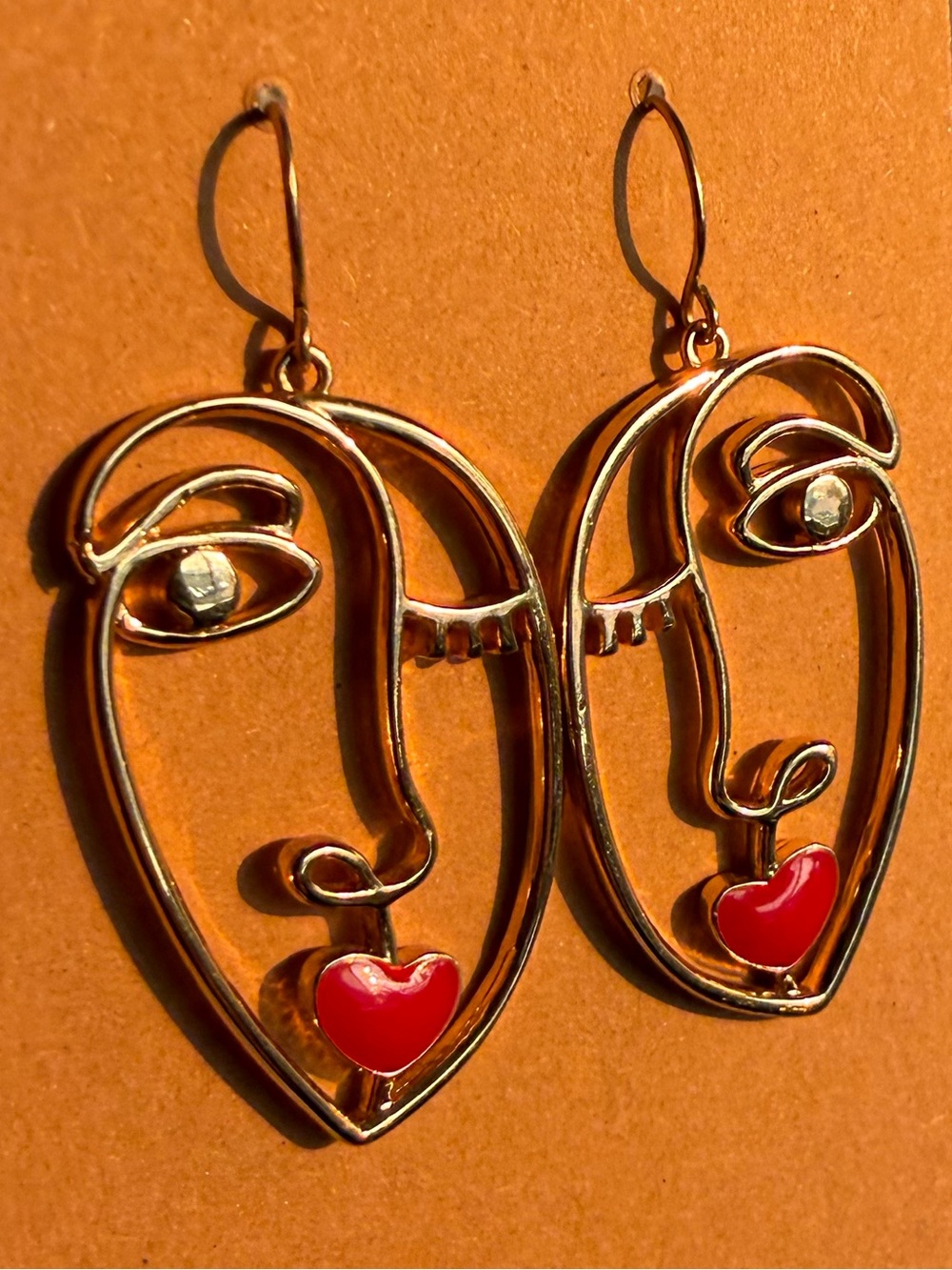 Gold Abstract Face Earrings with Red Heart Accent